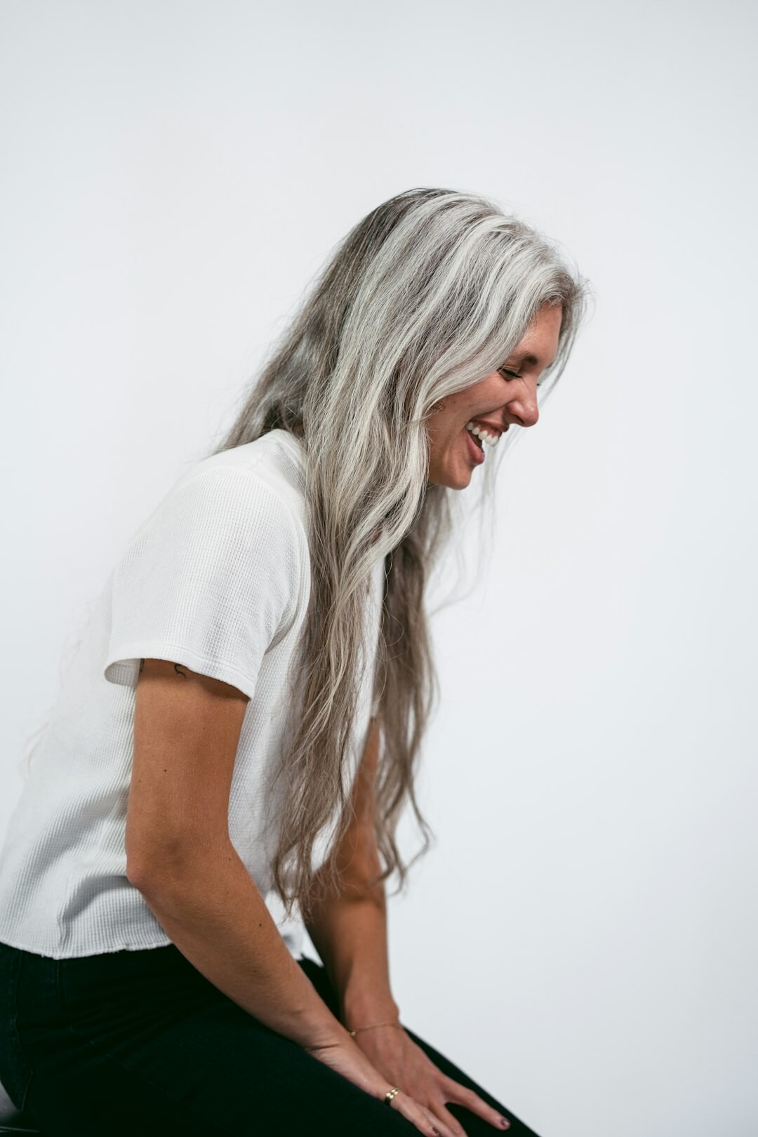 Studio portrait of a friendly Slovak senior woman with short grey hair smiling