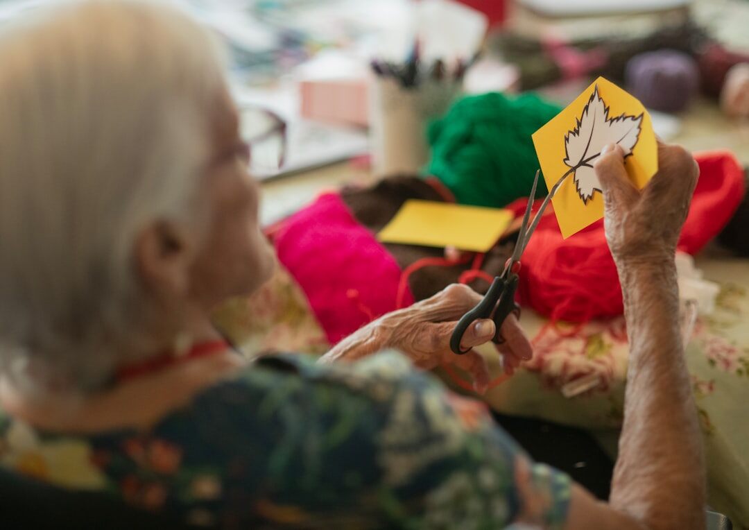 Seniors attending a creative handicraft workshop indoors