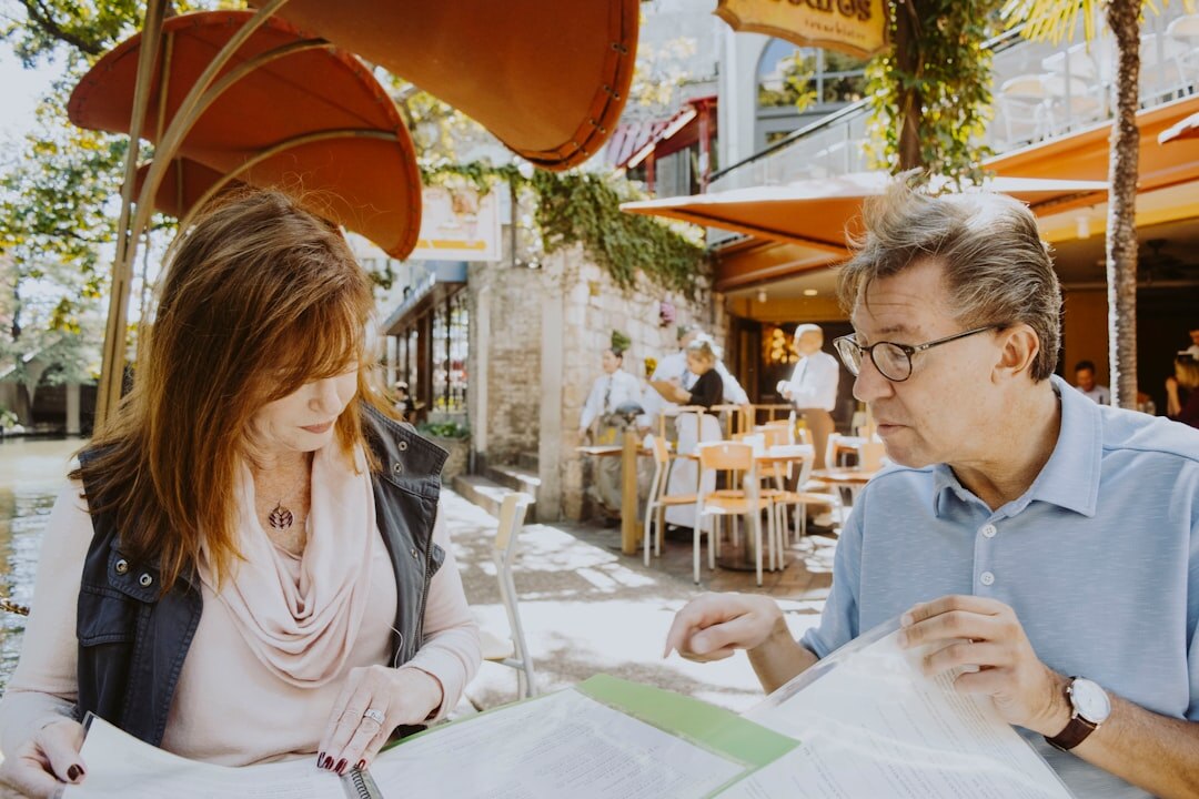 elderly couple reading documents