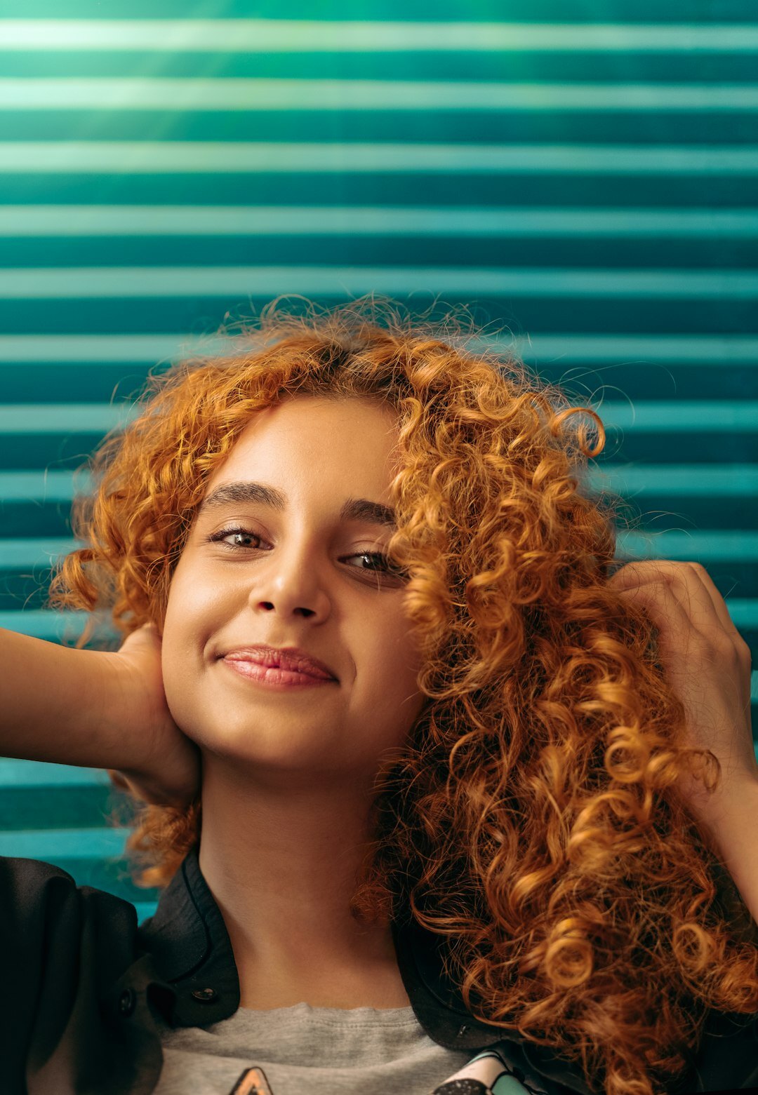 Studio portrait of a cheerful middle aged Slovak woman with curly hair